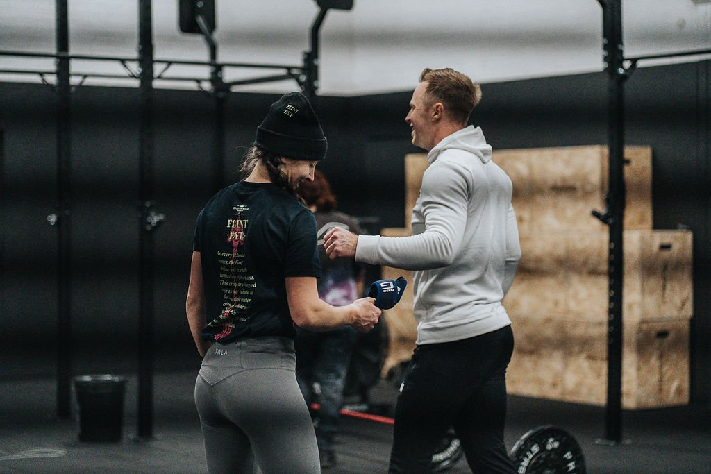 Two people in a gym laughing